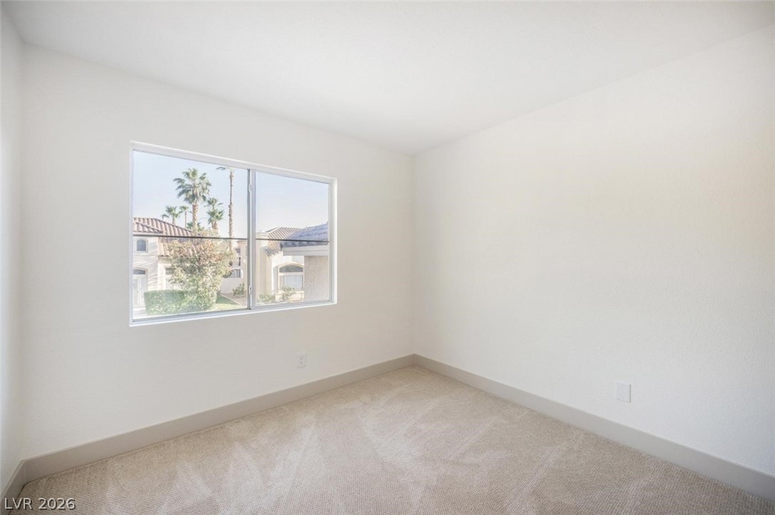 2651 Ridgewater Circle Henderson, NV 89074 - Photo 18 of 27 This bright bedroom offers tranquil views, perfect for peaceful mornings and serene evenings.