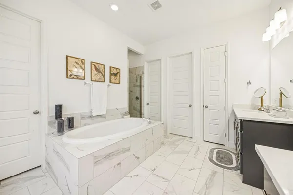 a spacious bathroom with a sink a mirror and a shower