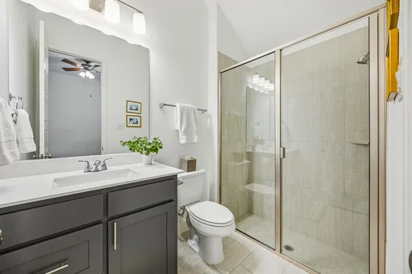 a bathroom with a sink toilet and shower