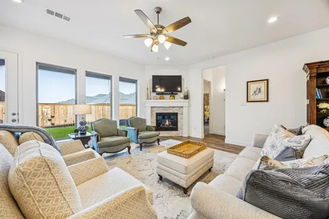 a living room with furniture a fireplace and a flat screen tv