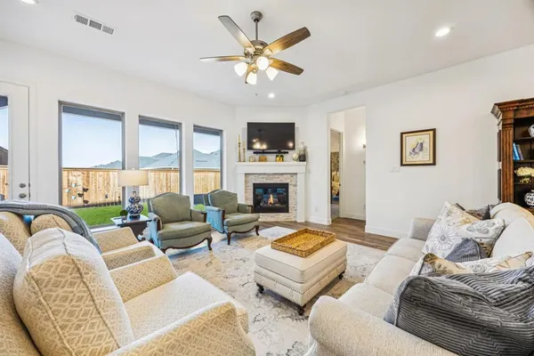 a living room with furniture a fireplace and a flat screen tv
