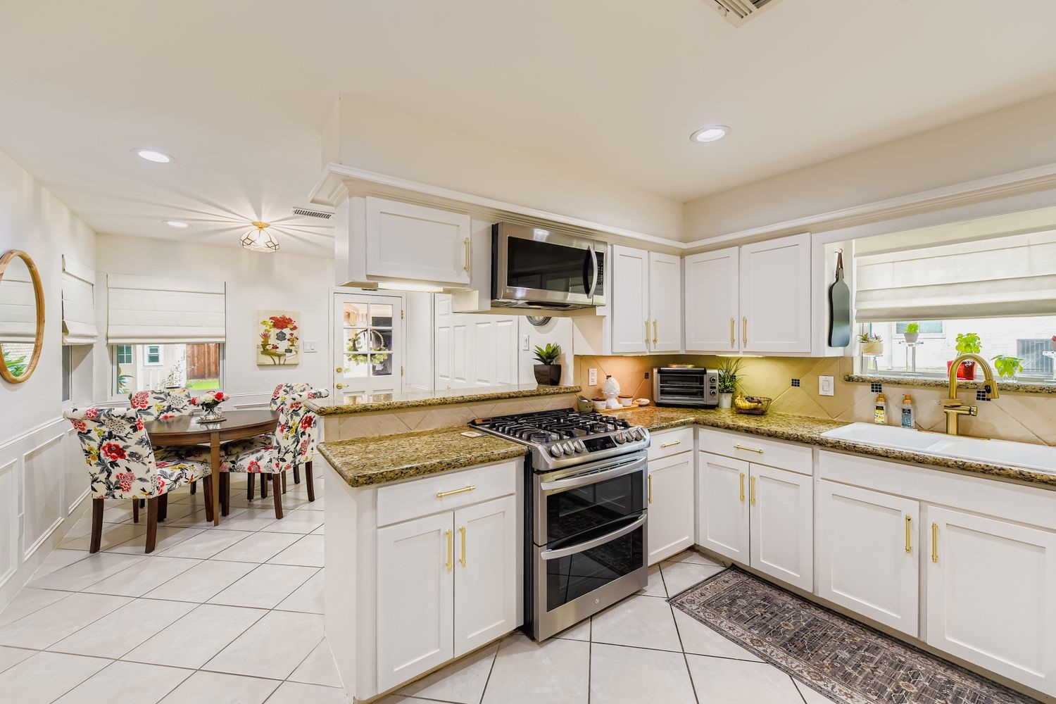 610 Andover Street Spring, TX 77373 - Photo 10 of 26 a kitchen with a stove a sink and a refrigerator