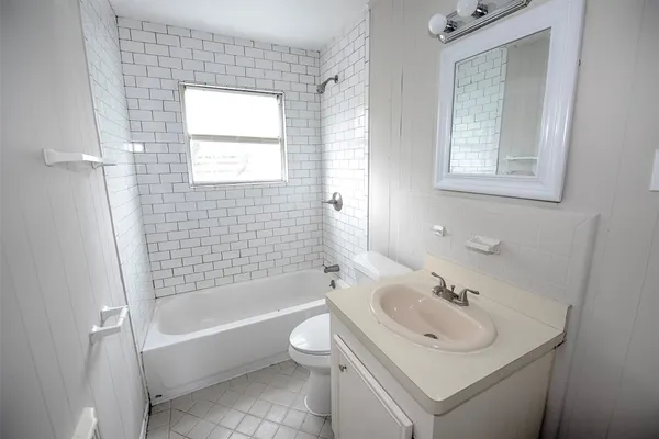 a bathroom with a sink toilet tub and shower