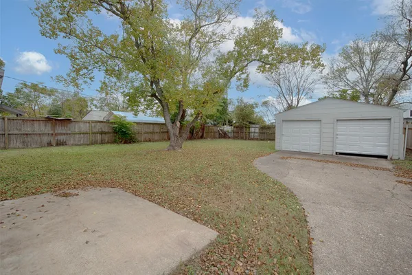 a view of a backyard with large tree