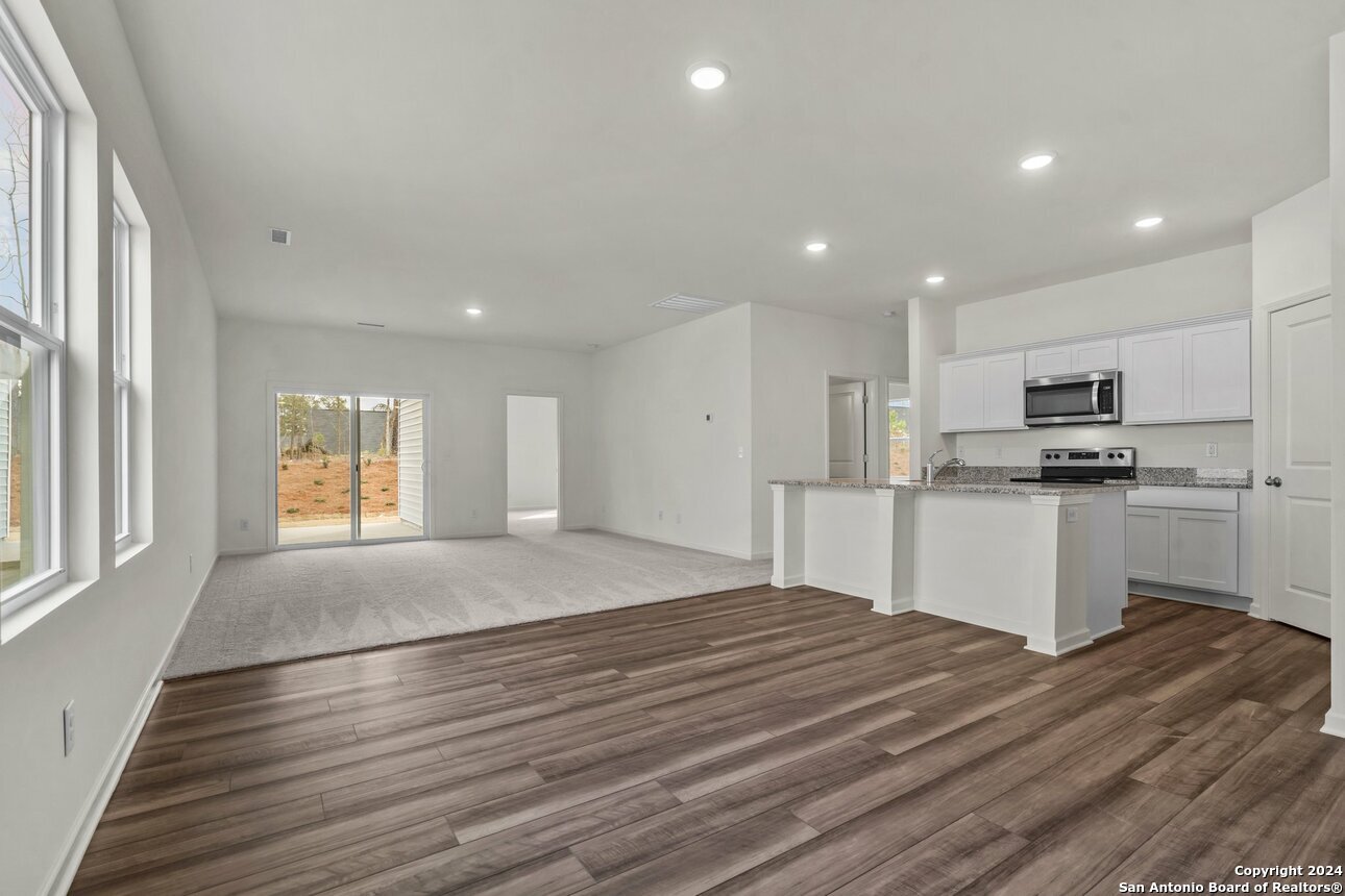 128 Dionicio Loop Seguin, TX 78155 - Photo 10 of 10 a kitchen with stainless steel appliances granite countertop a stove a sink and a refrigerator