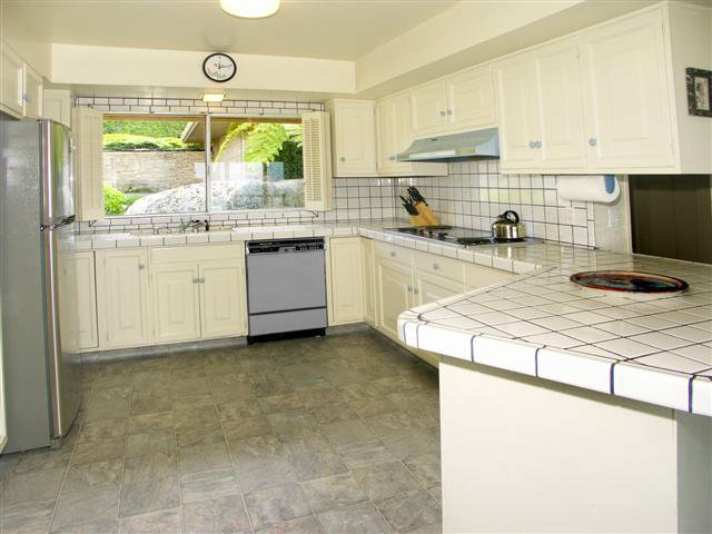 2705 Ribera Road Carmel, CA 93923 - Photo 11 of 22 a kitchen with granite countertop a stove a sink and a refrigerator