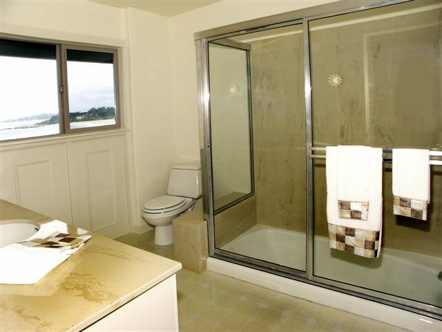 2705 Ribera Road Carmel, CA 93923 - Photo 18 of 22 a bathroom with a granite countertop sink a toilet and shower