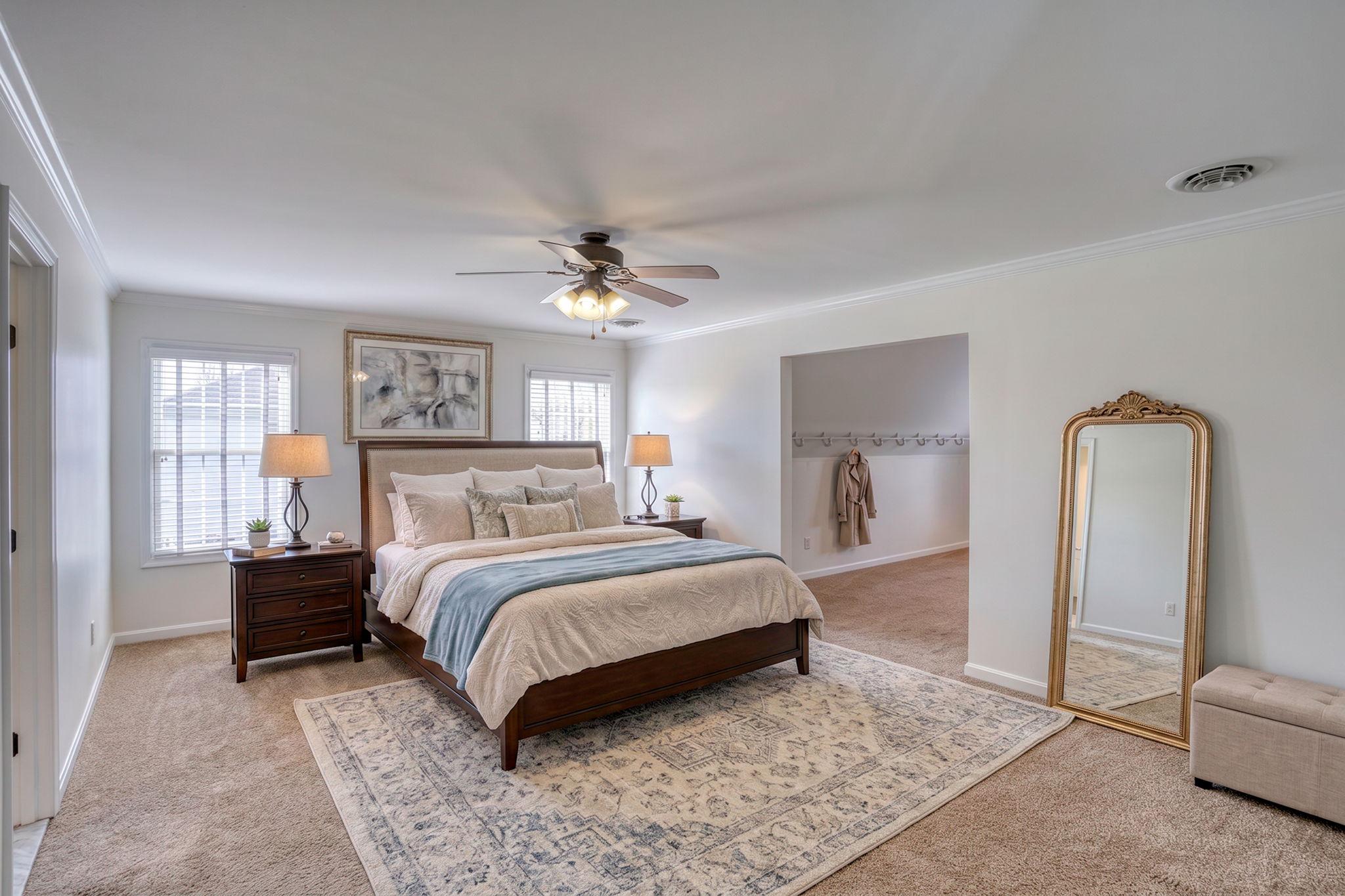 210 Grapevine Way Milford, DE 19963 - Photo 19 of 61 a spacious bedroom with a bed a couch and dresser