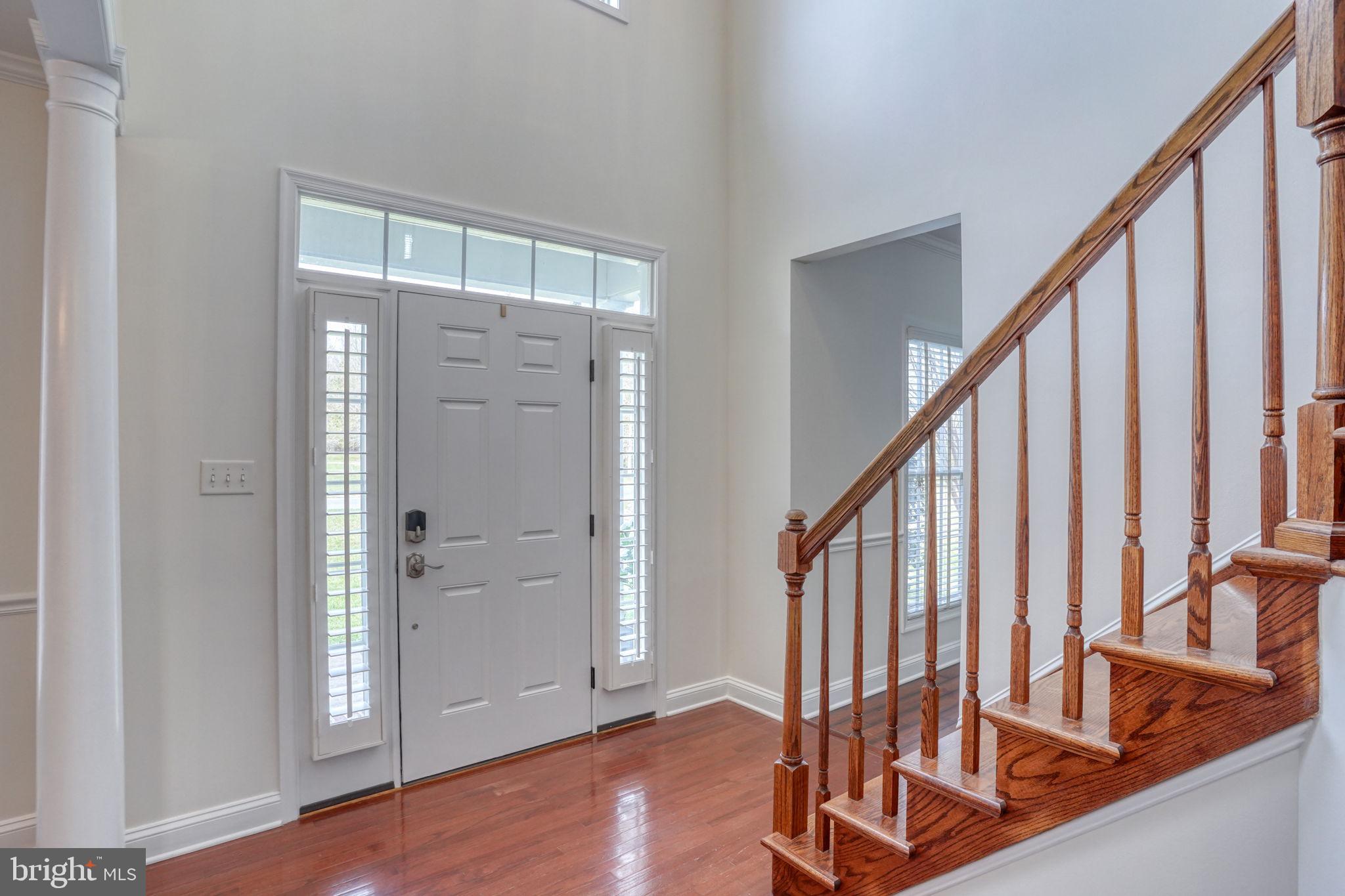 210 Grapevine Way Milford, DE 19963 - Photo 23 of 61 a view of an entryway with wooden floor and door