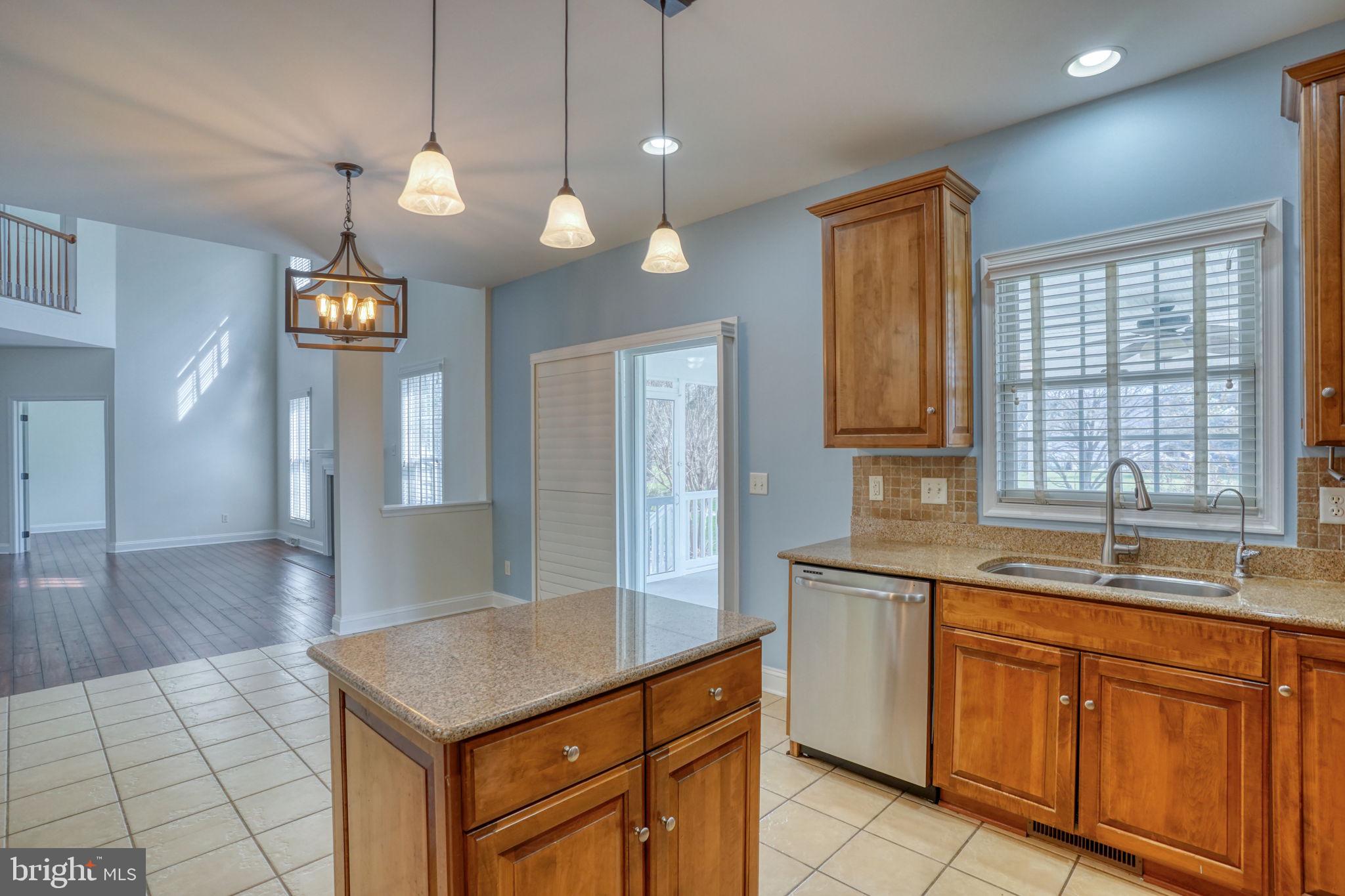 210 Grapevine Way Milford, DE 19963 - Photo 40 of 61 a kitchen with cabinets a center island and windows