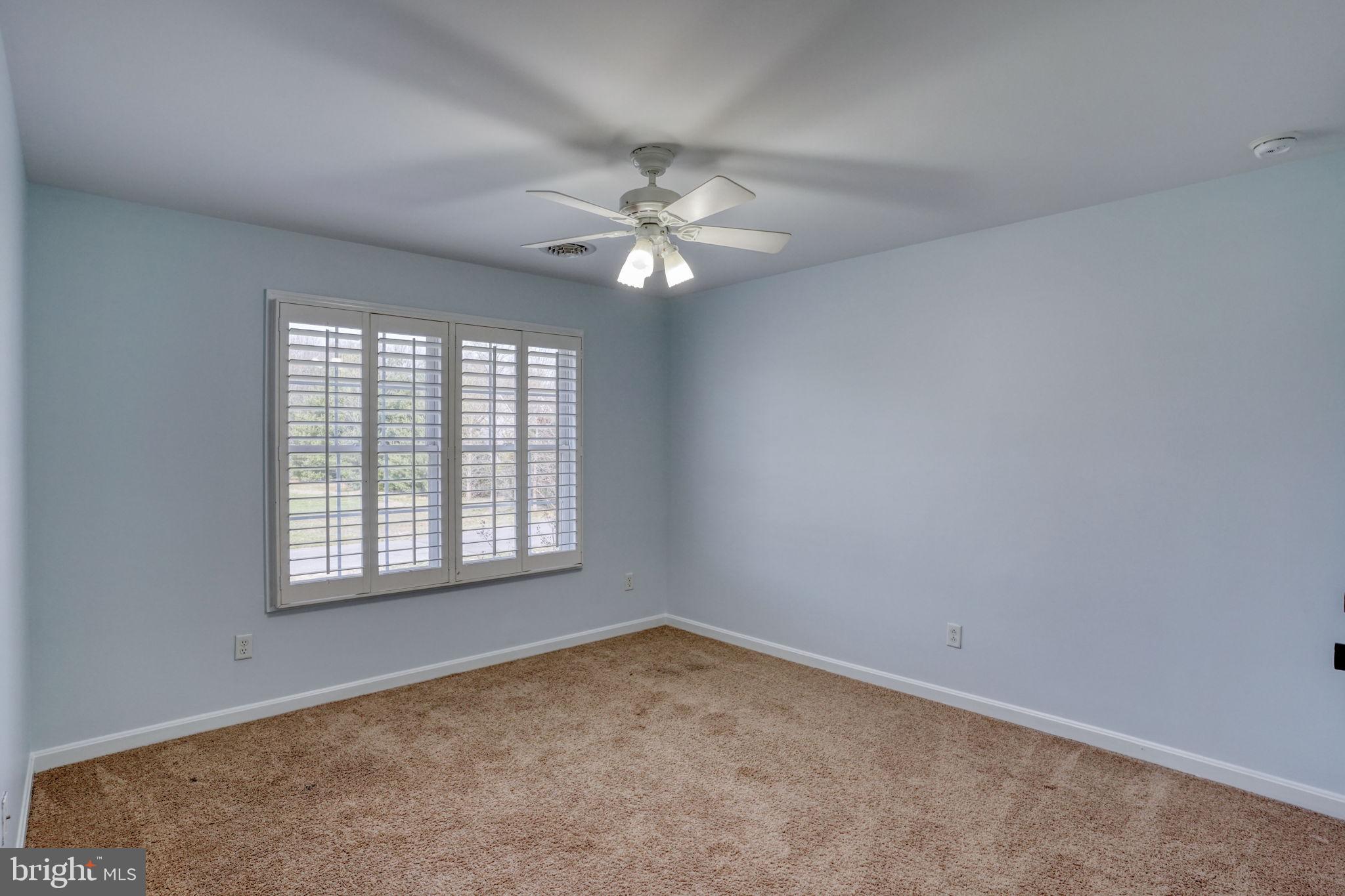 210 Grapevine Way Milford, DE 19963 - Photo 45 of 61 an empty room with a window and a fan