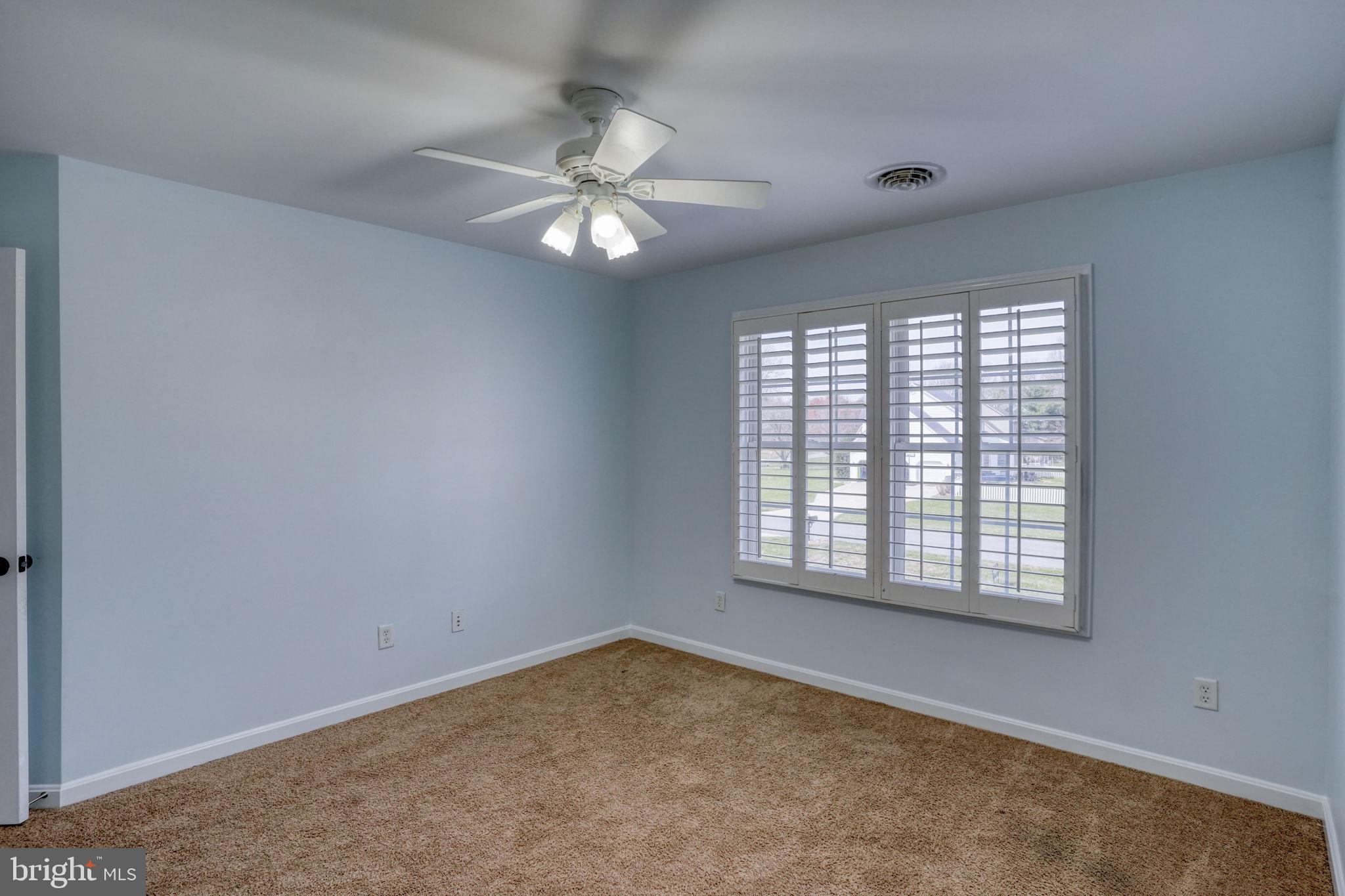 210 Grapevine Way Milford, DE 19963 - Photo 46 of 61 an empty room with windows and fan