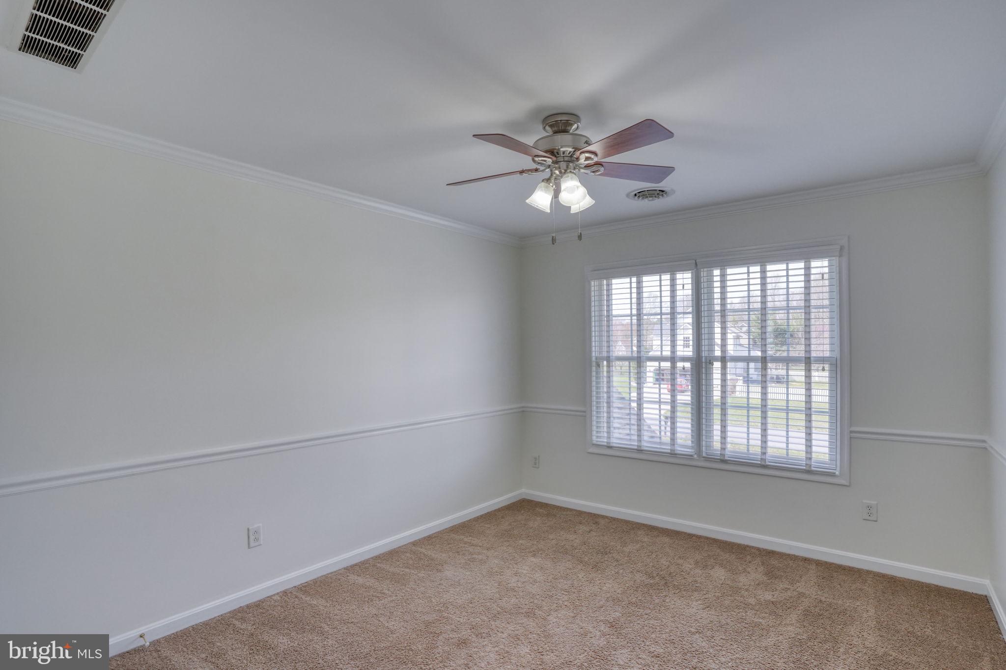 210 Grapevine Way Milford, DE 19963 - Photo 51 of 61 an empty room with windows and fan