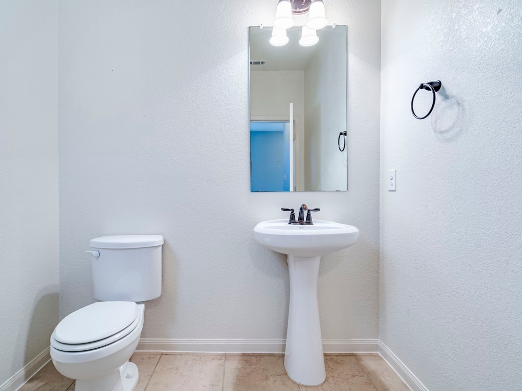 216 Isabel Lane Kyle, TX 78640 - Photo 13 of 27 a bathroom with a sink toilet and a mirror