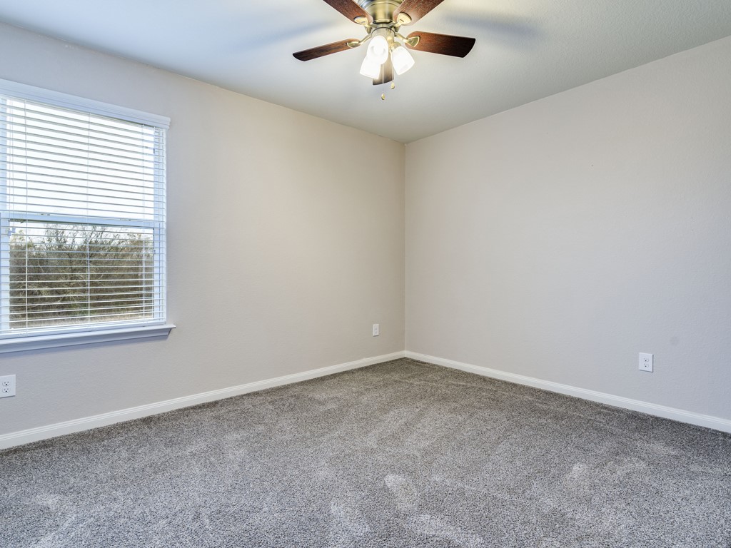 216 Isabel Lane Kyle, TX 78640 - Photo 17 of 27 a view of an empty room with a window