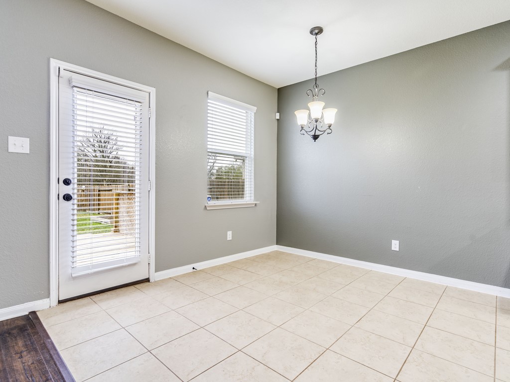 216 Isabel Lane Kyle, TX 78640 - Photo 8 of 27 a view of a livingroom with a chandelier fan and windows