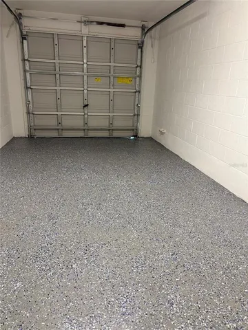 a living room with furniture kitchen view and a chandelier