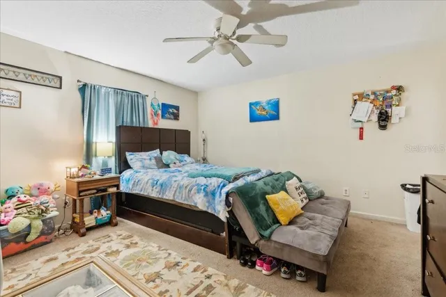 a bedroom with a bed a couch and a window