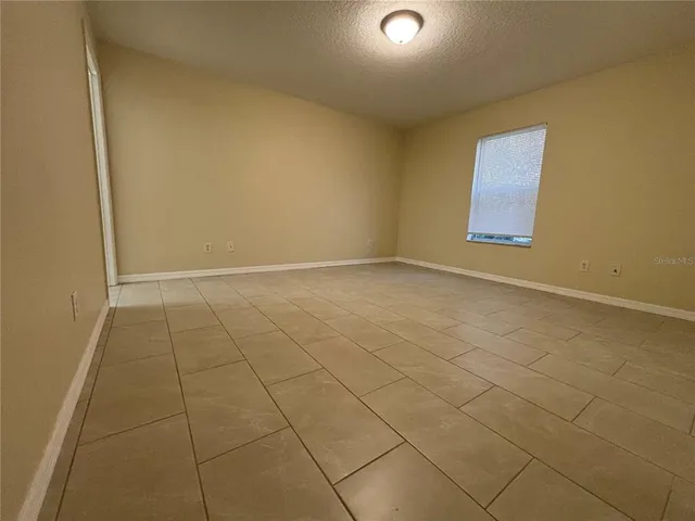 an empty room with white walls and tiles