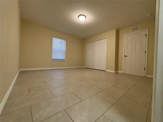 a view of an empty room and a window