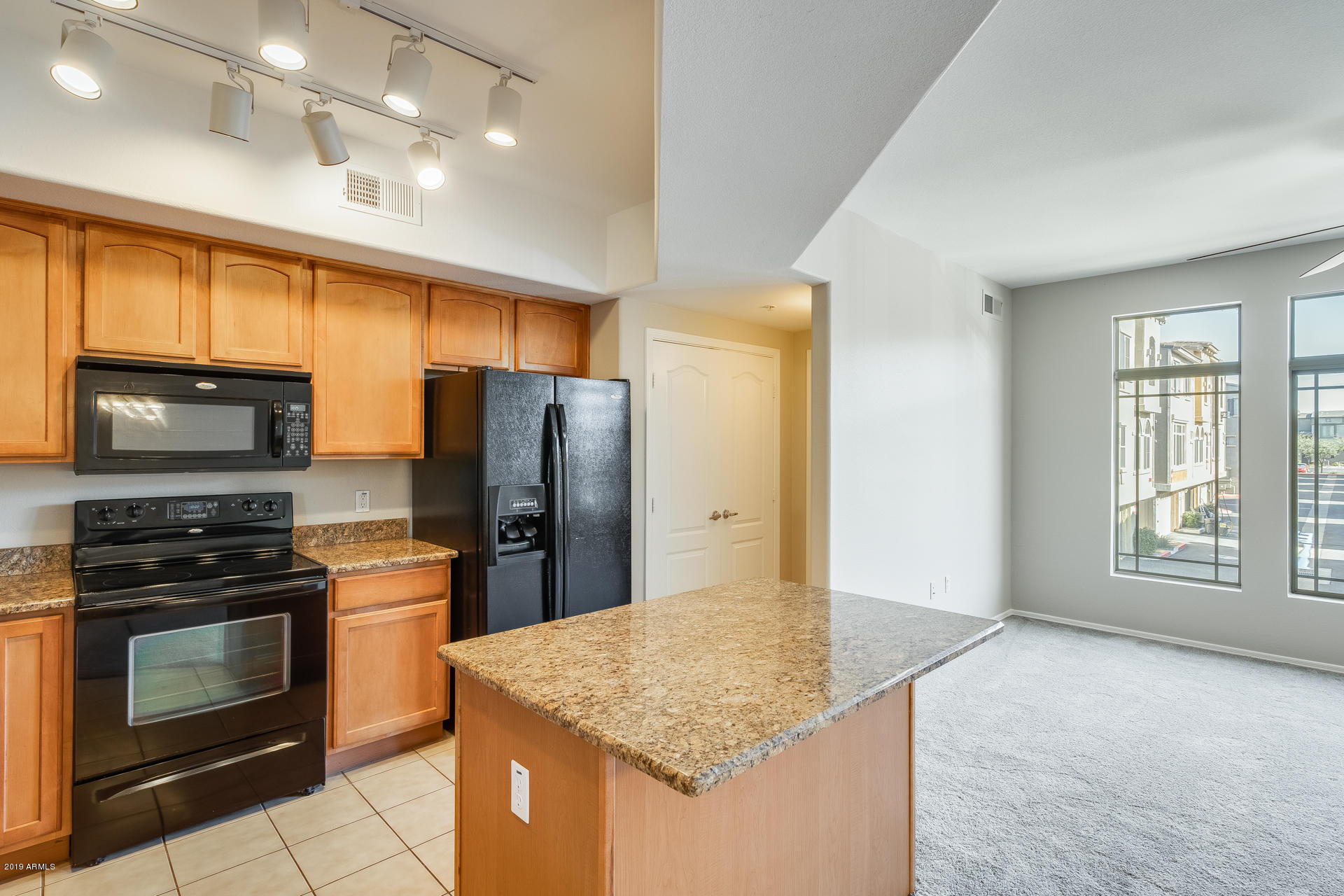 2401 East Rio Salado Parkway, Unit 1124 Tempe, AZ 85288 - Photo 10 of 32 a kitchen with stainless steel appliances granite countertop a stove a refrigerator and a sink