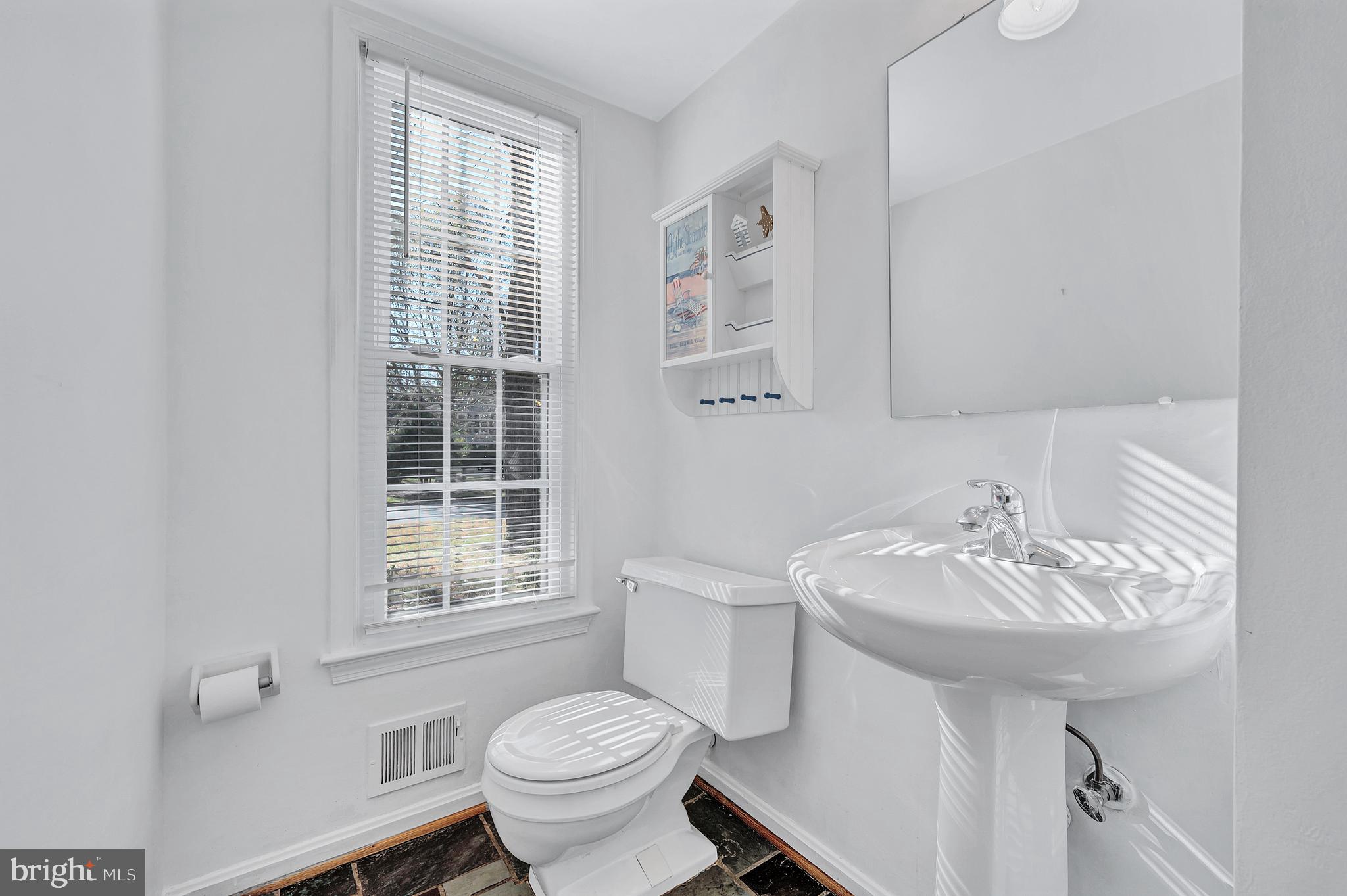 8617 Atwell Road Potomac, MD 20854 - Photo 21 of 39 a bathroom with a sink toilet and a mirror