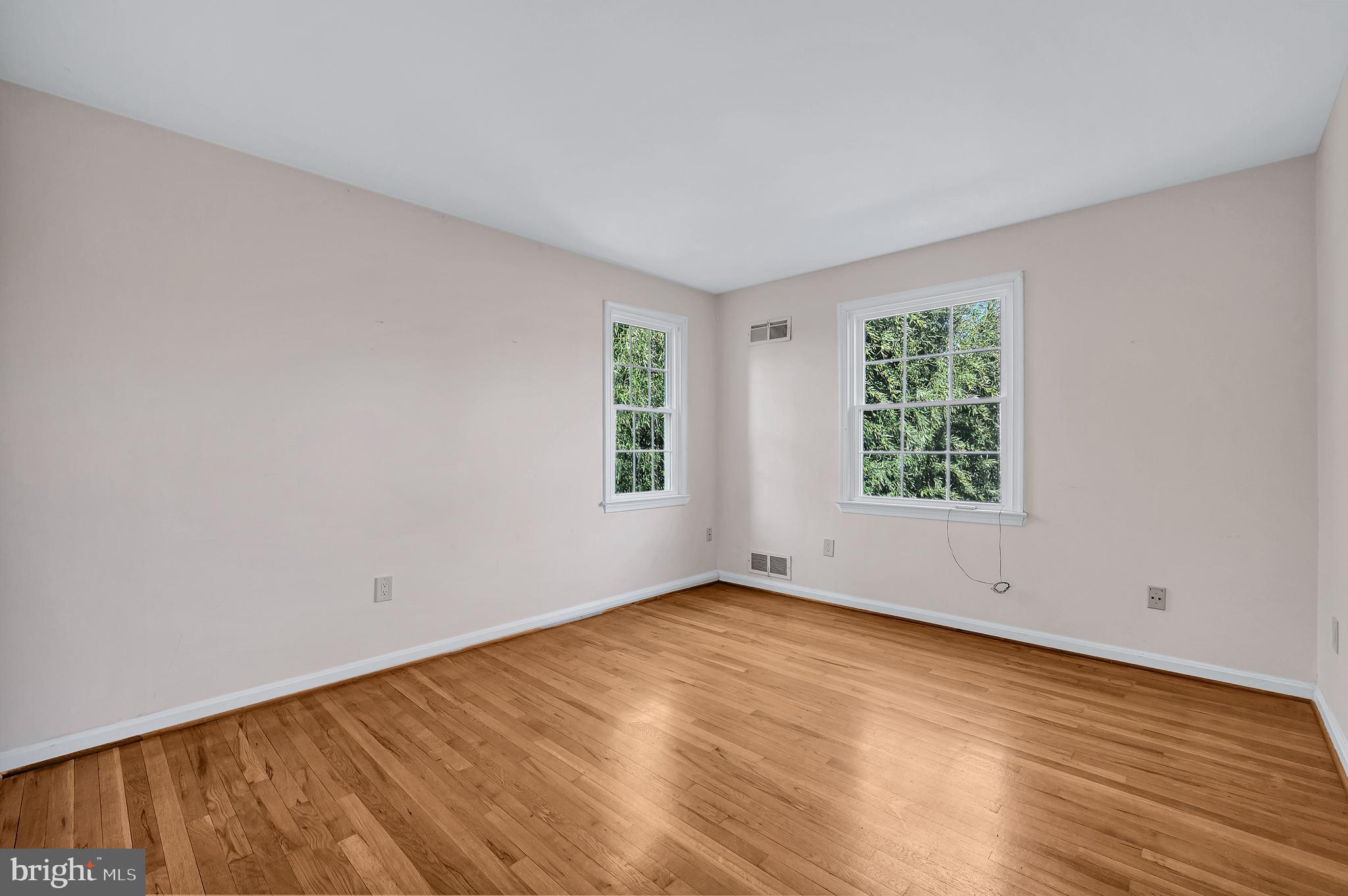 8617 Atwell Road Potomac, MD 20854 - Photo 23 of 39 an empty room with wooden floor and windows