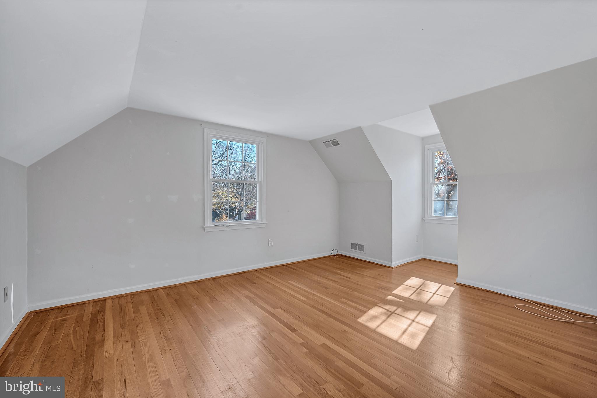 8617 Atwell Road Potomac, MD 20854 - Photo 27 of 39 a view of an empty room with wooden floor