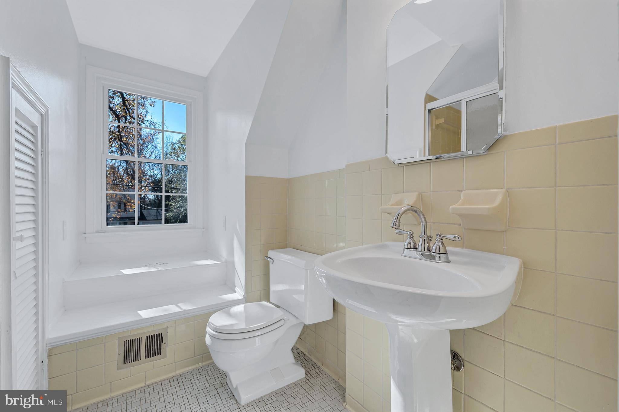 8617 Atwell Road Potomac, MD 20854 - Photo 29 of 39 a bathroom with a sink toilet and mirror