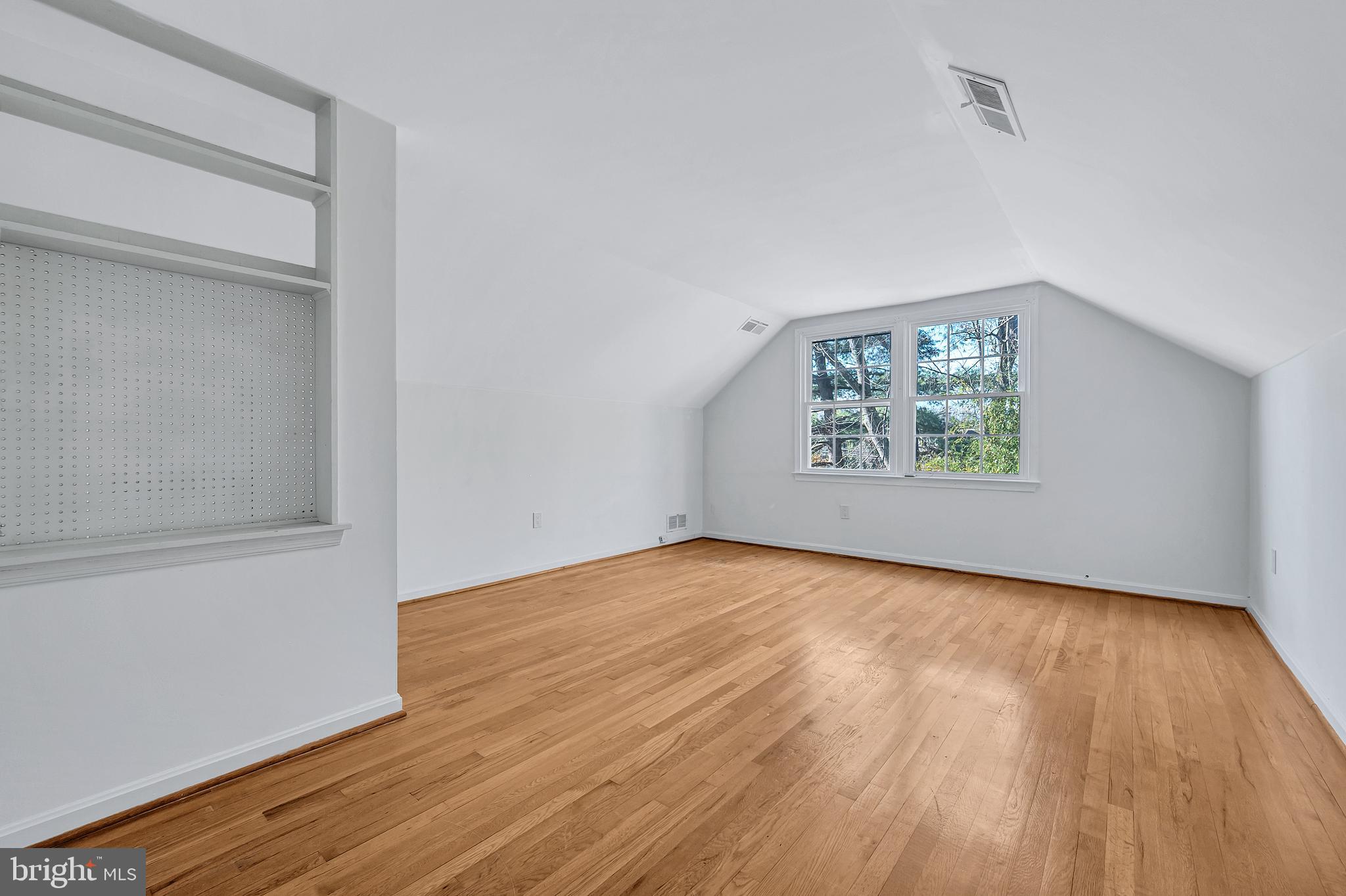 8617 Atwell Road Potomac, MD 20854 - Photo 32 of 39 an empty room with wooden floor and windows