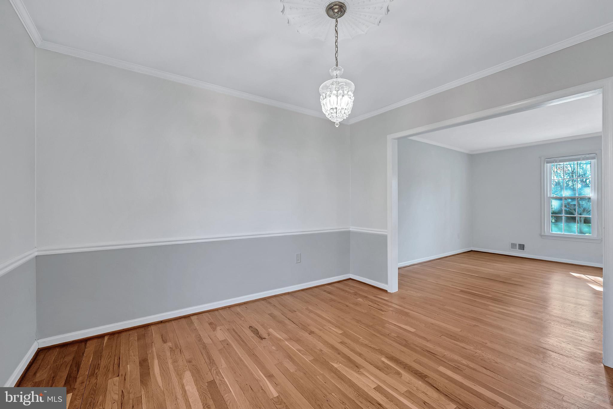 8617 Atwell Road Potomac, MD 20854 - Photo 6 of 39 a view of an empty room with wooden floor and a window