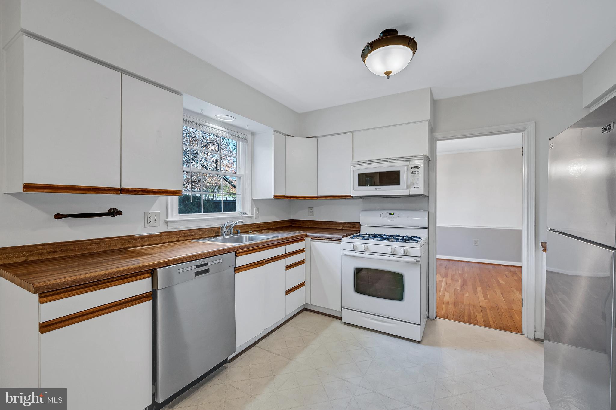 8617 Atwell Road Potomac, MD 20854 - Photo 8 of 39 a kitchen with cabinets stainless steel appliances a sink and a window