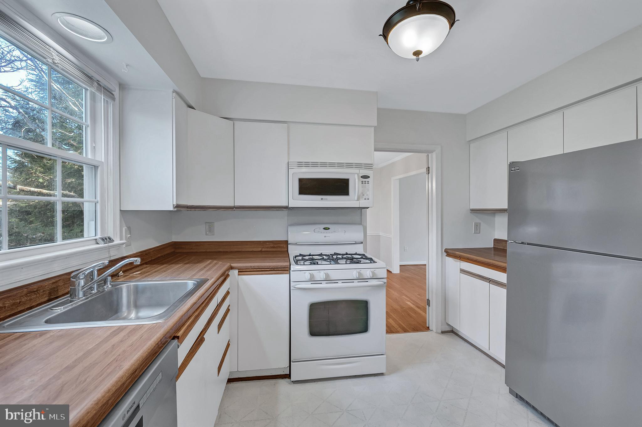 8617 Atwell Road Potomac, MD 20854 - Photo 9 of 39 a kitchen with granite countertop a sink stainless steel appliances and cabinets