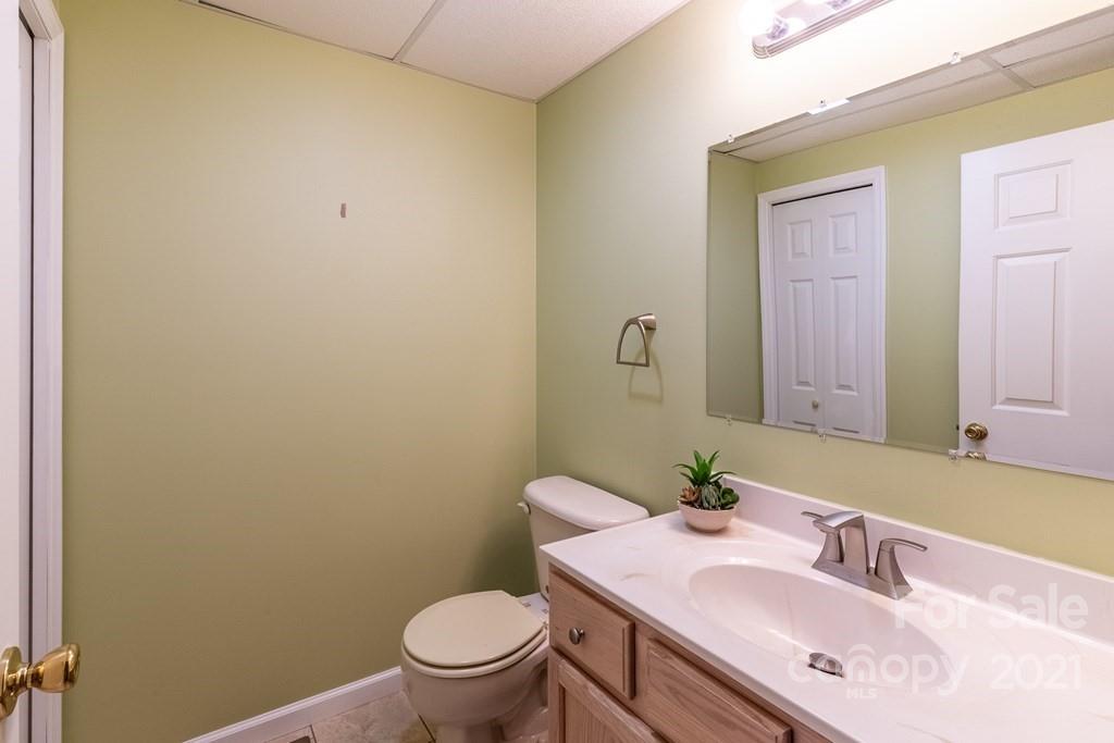 30 Ridge Point, Unit 1 Sylva, NC 28779 - Photo 8 of 42 a bathroom with a sink vanity mirror and toilet