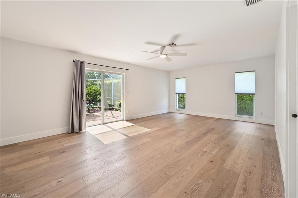 508 Devils Lane Naples, FL 34103 - Photo 17 of 35 a view of empty room with wooden floor and fan