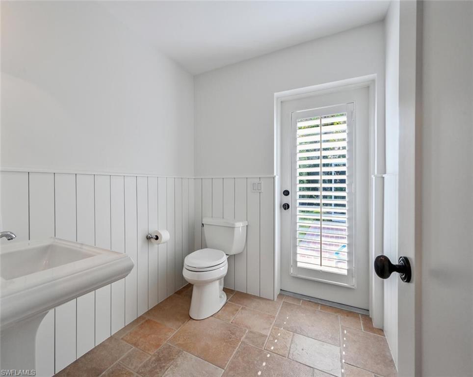 508 Devils Lane Naples, FL 34103 - Photo 24 of 35 a bathroom with a toilet a sink and a window