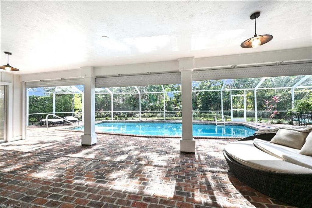 508 Devils Lane Naples, FL 34103 - Photo 26 of 35 a living room with a large window and a table