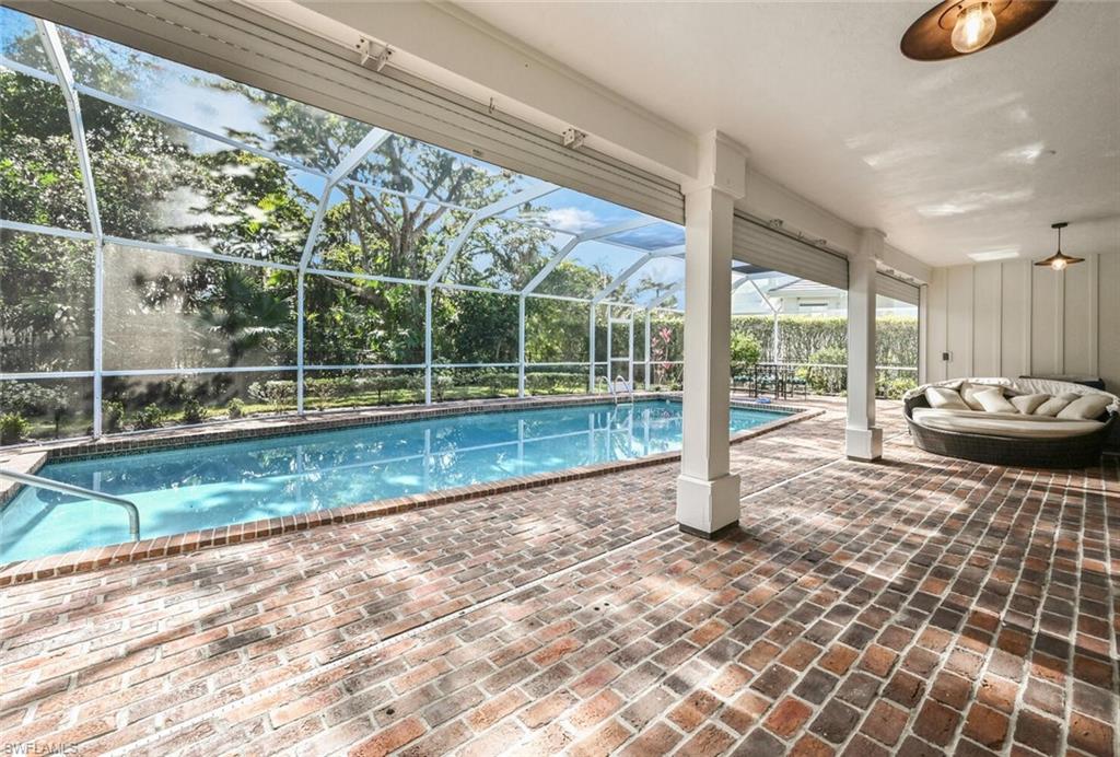 508 Devils Lane Naples, FL 34103 - Photo 27 of 35 a view of a porch with a floor to ceiling window next to a yard