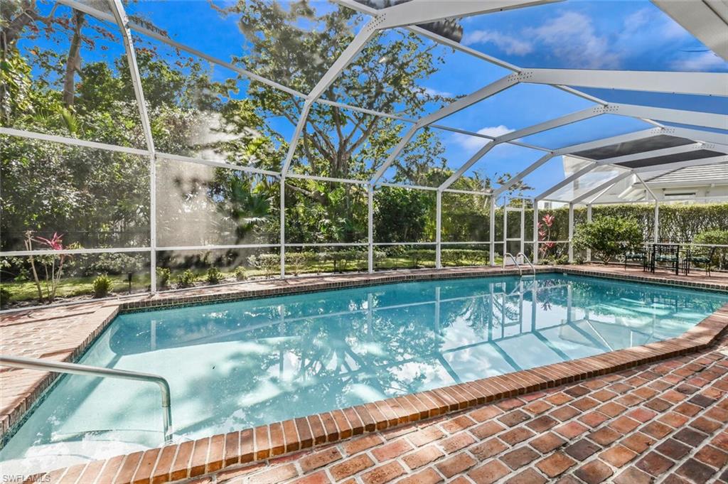 508 Devils Lane Naples, FL 34103 - Photo 29 of 35 a view of a swimming pool with a porch