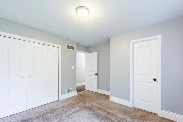 an empty room with closet area