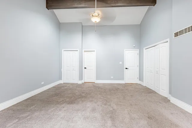 an empty room with a ceiling fan