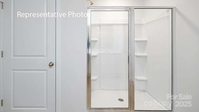 a bathroom with a glass shower door