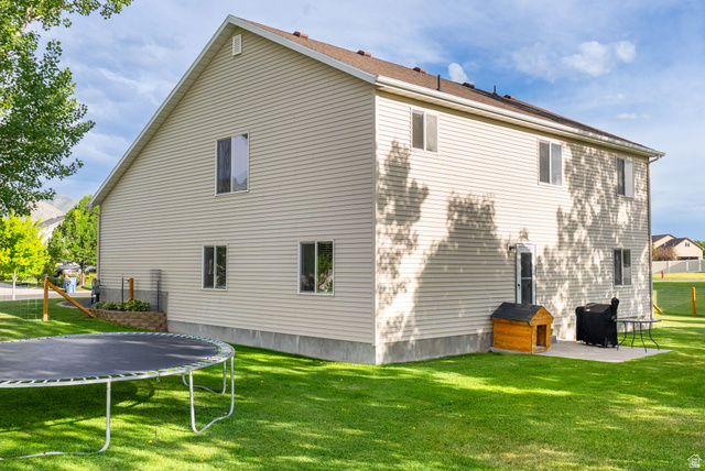 2485 South 1100th Street West Logan, UT 84321 - Photo 39 of 53 Cream-colored siding exterior featuring multiple windows and a brown shingle roof