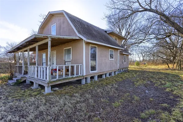 a view of a house with a yard and deck