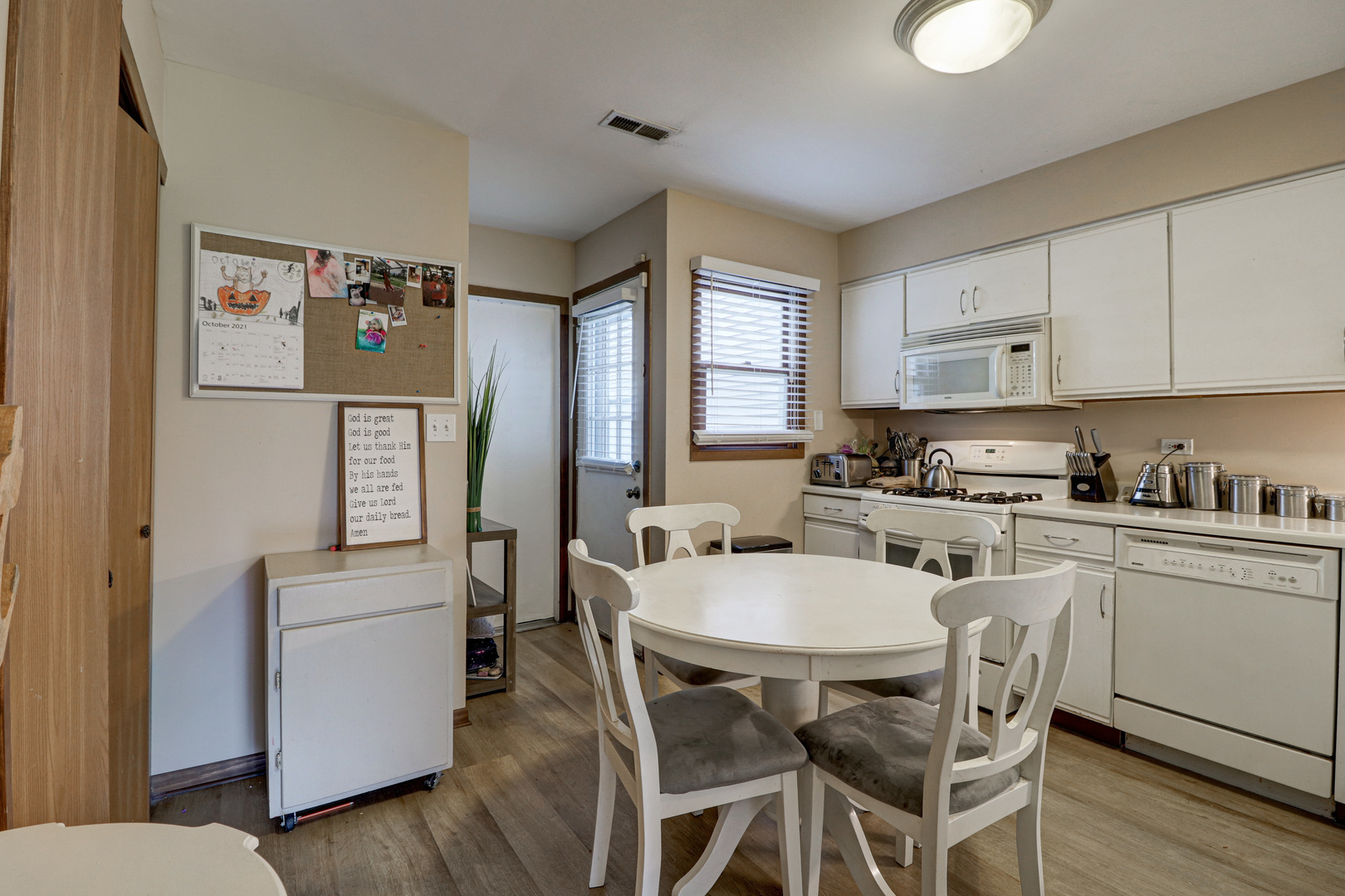 17482 Chestnut Lane Gurnee, IL 60031 - Photo 4 of 23 a kitchen with stainless steel appliances white cabinets and wooden floor
