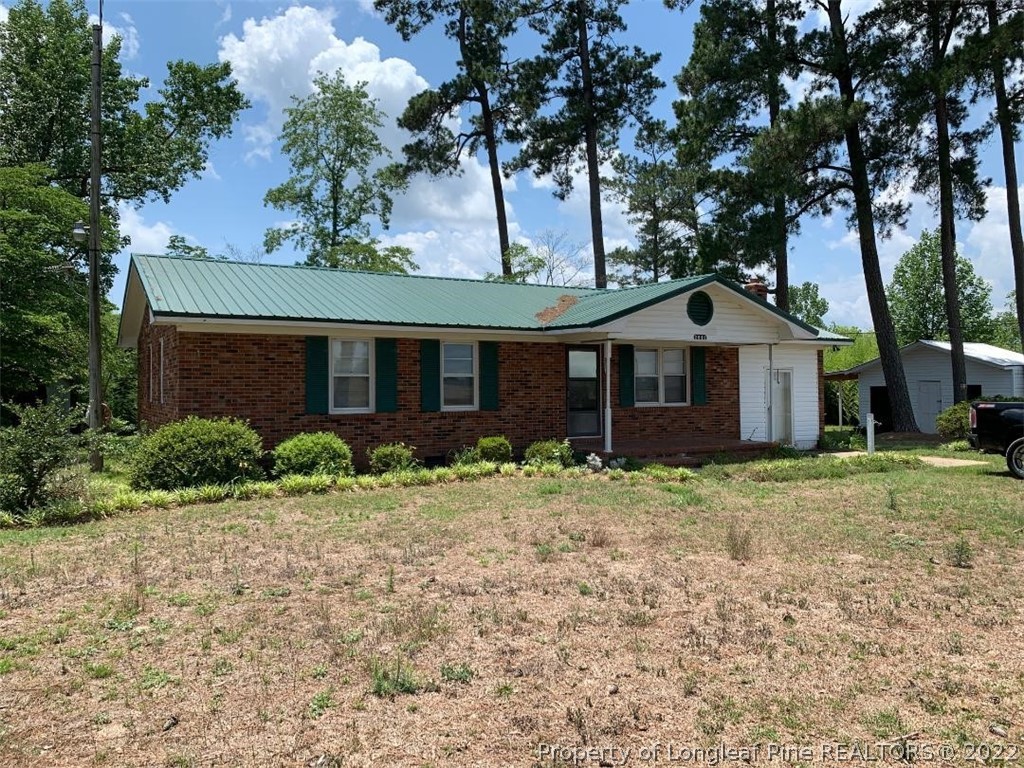 2681 Raynham Road Fairmont, NC 28340 - Photo 1 of 10 a front view of a house with a garden