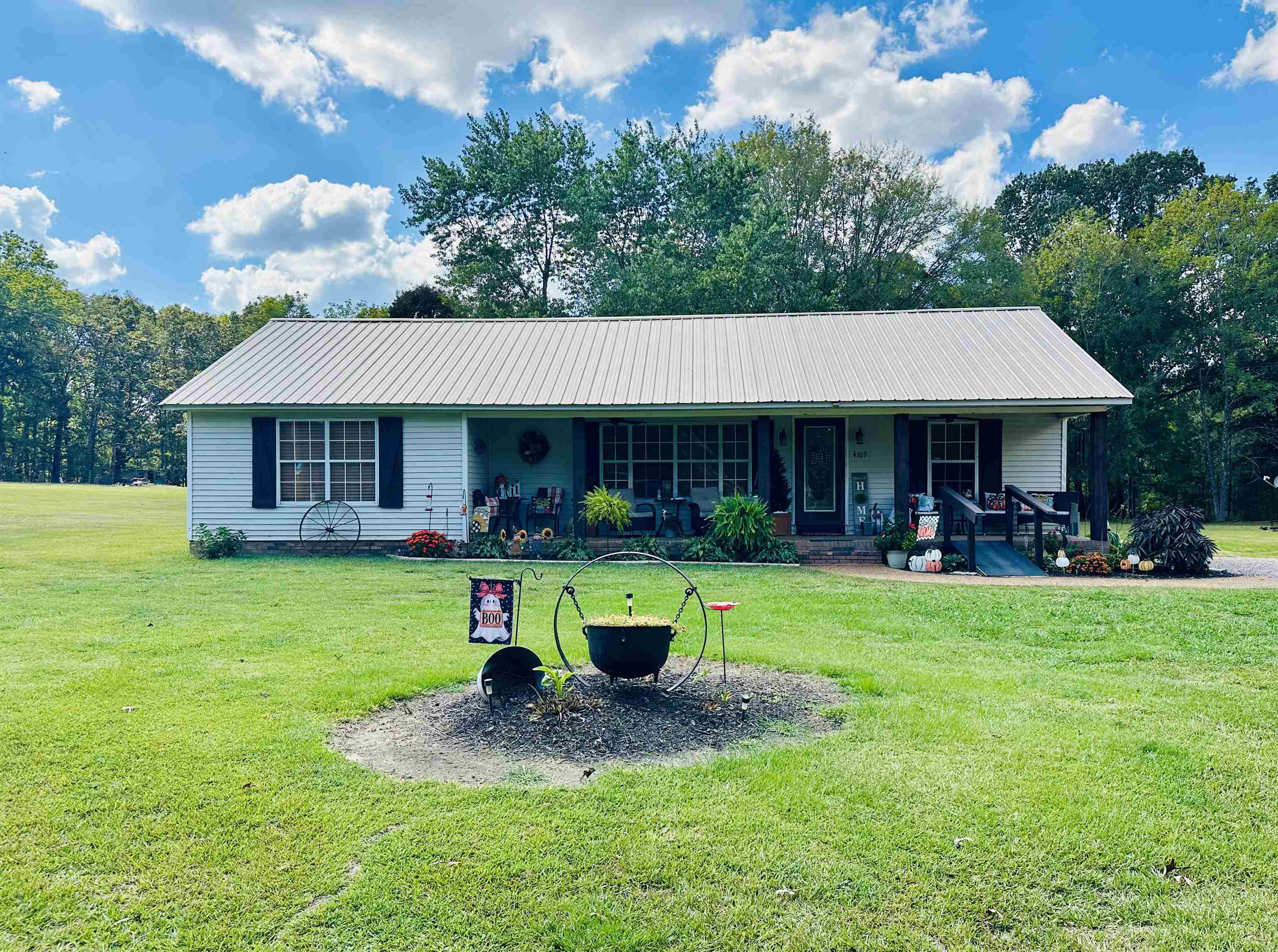 a front view of a house with swimming pool having outdoor seating