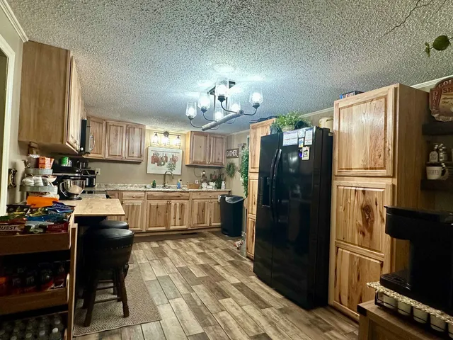 a kitchen with stainless steel appliances a refrigerator stove and sink
