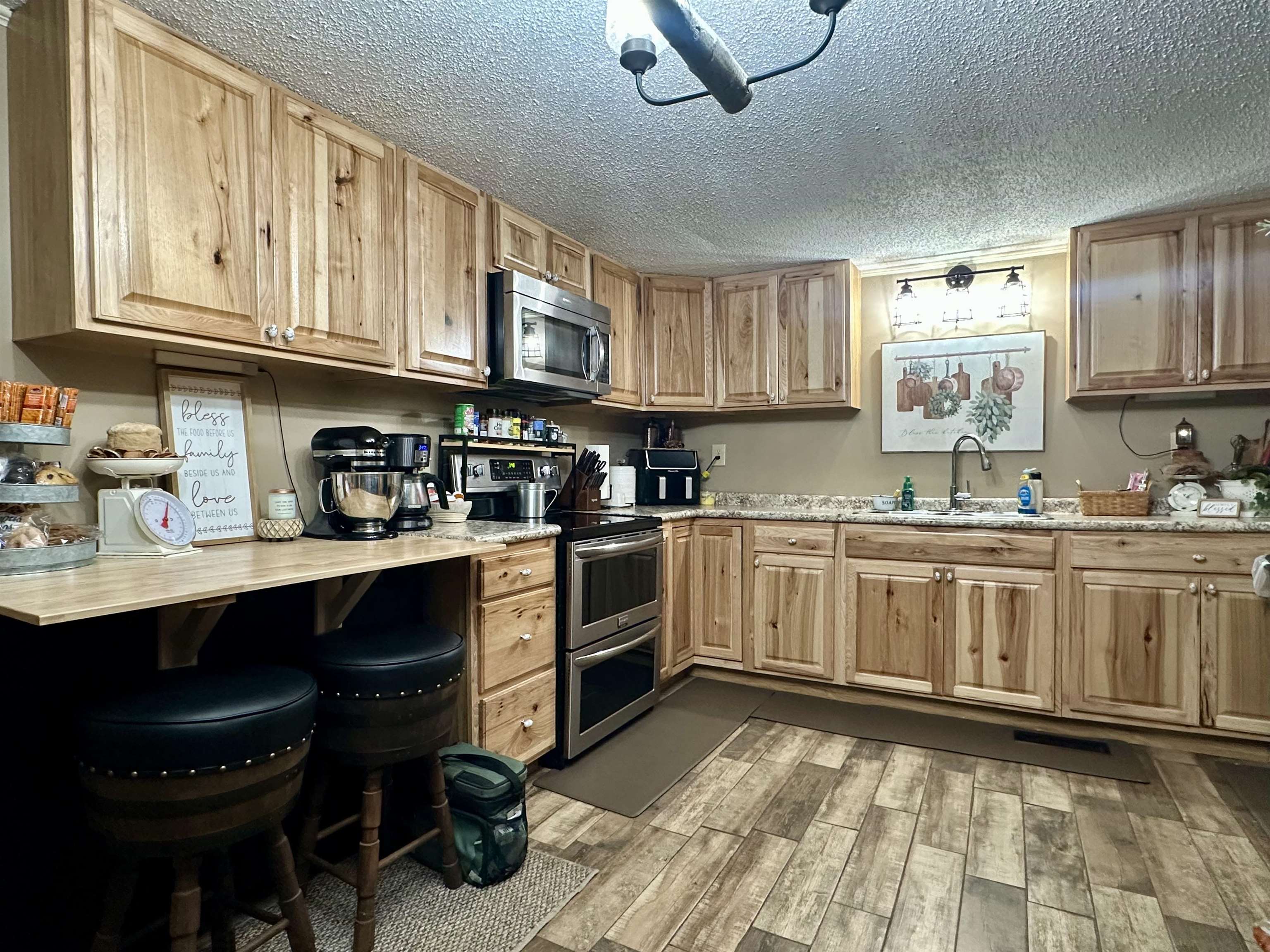 4769 Pleasant Site Road Selmer, TN 38375 - Photo 12 of 28 a kitchen with stainless steel appliances granite countertop a stove a sink dishwasher and cabinets with wooden floor