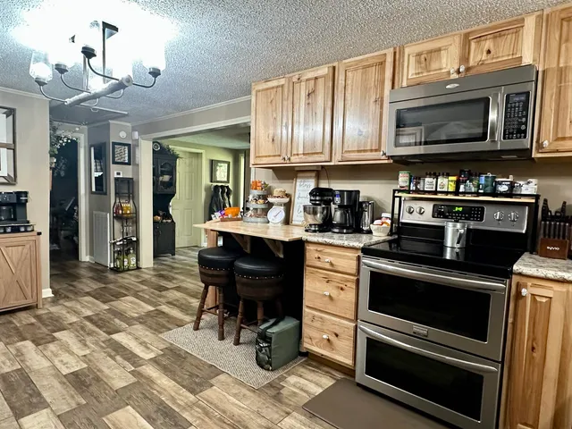 a kitchen with stainless steel appliances a stove a sink and cabinets